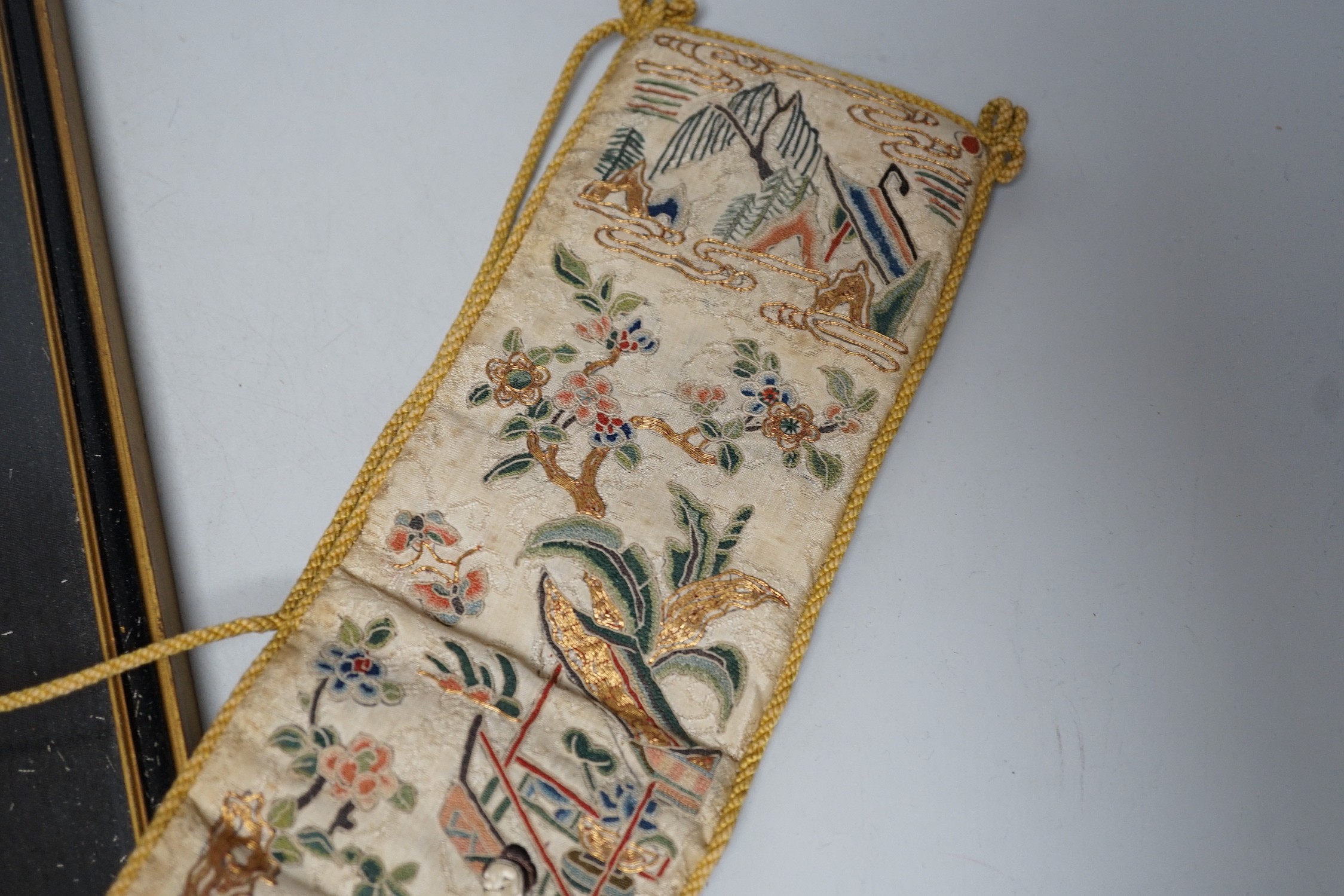 A pair of Chinese 19th century figurative sleeve bands, embroidered with polychrome and metallic threads, stitched in Peking knot and a Chinese embroidered silk purse, with a later panel, (3)